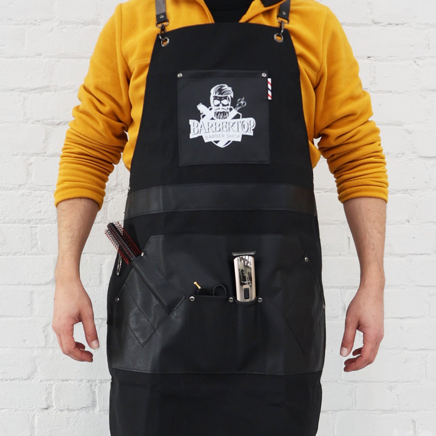 Professional Barber Apron by Barbertop shown with hair clippers and combs in pockets